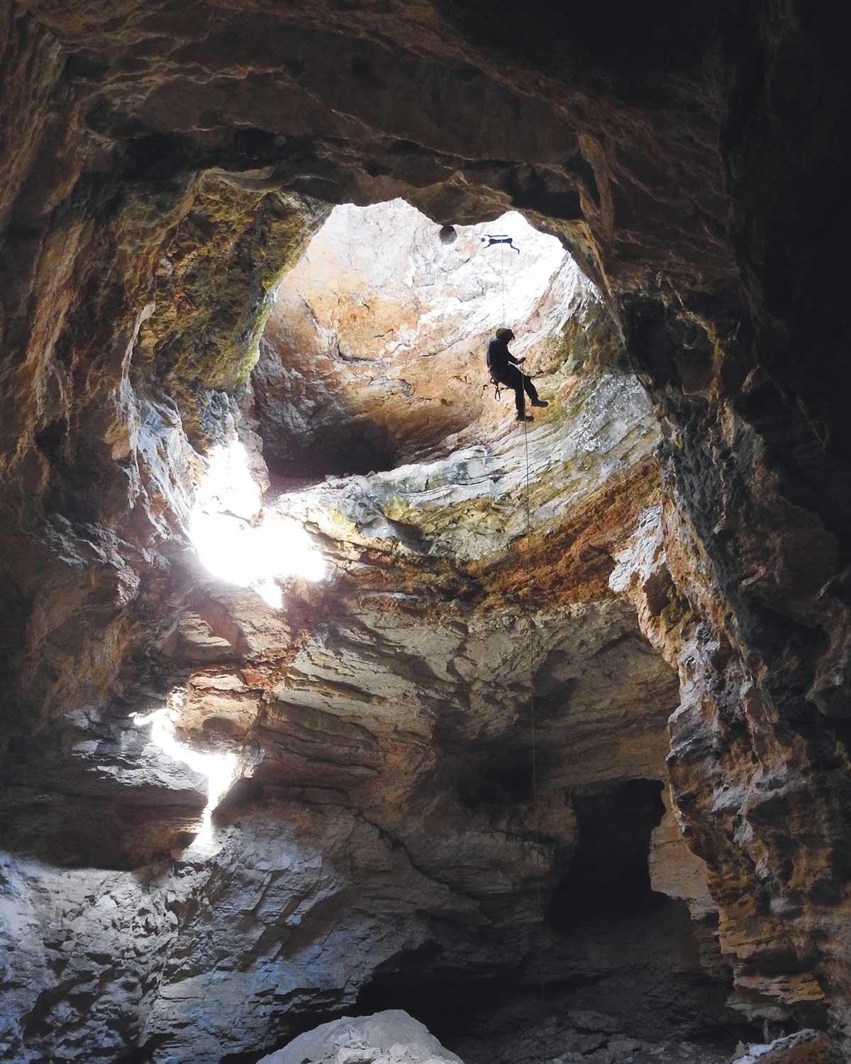 Person descending into a cave