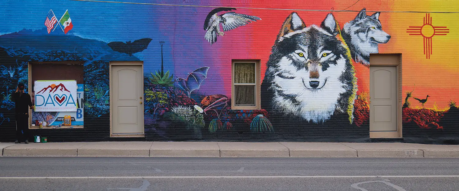 mural depicting bats, cacti, wolves, eagles, and an American and Mexican flag