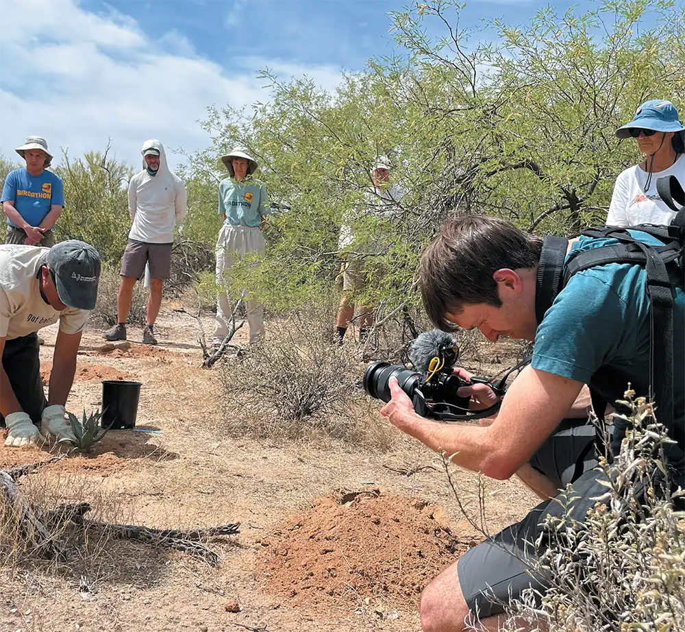 Dan Taylor planting agave in front of people