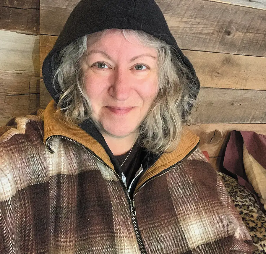 Zoe Klein wearing a brown jacket