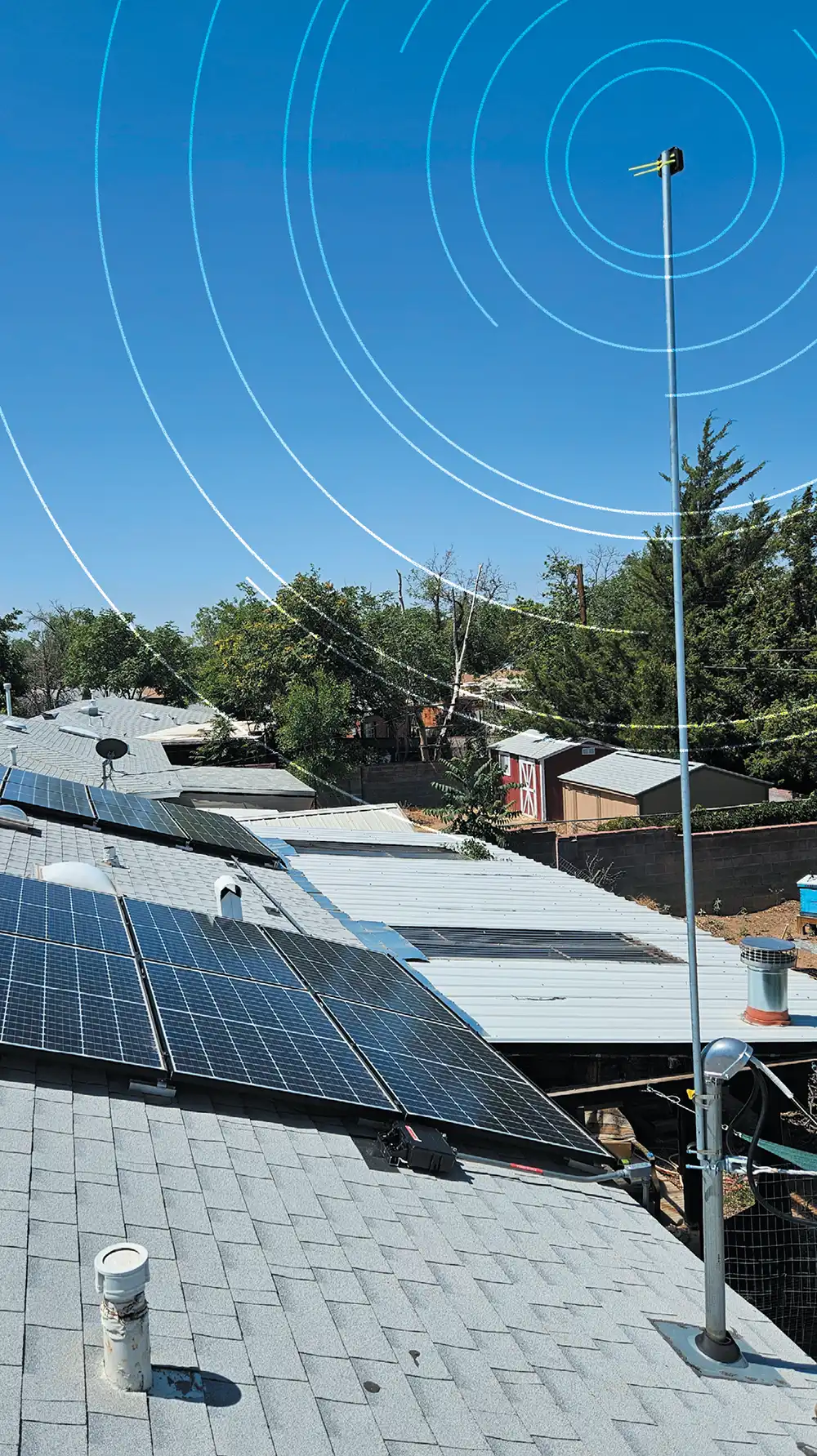 Rooftops with solar panels under a clear blue sky with overlayed concentric circles.